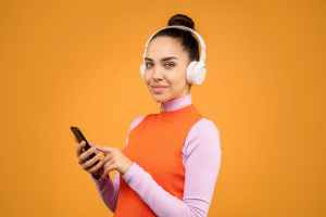 woman in orange pink long sleeve shirt holding black smartphone